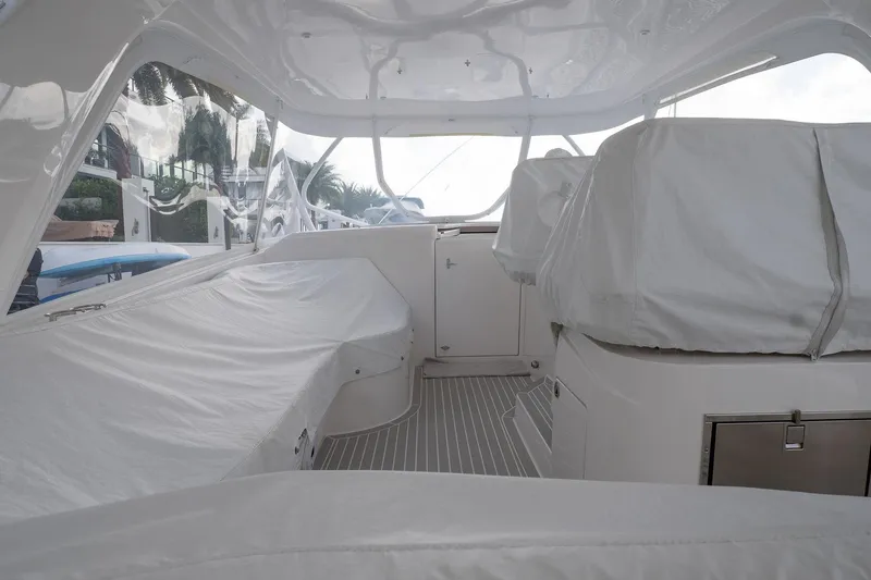 Slide: The Image of Interior view of 2022 Intrepid 477 Evolution yacht, featuring covered seating and sleek design. - 24