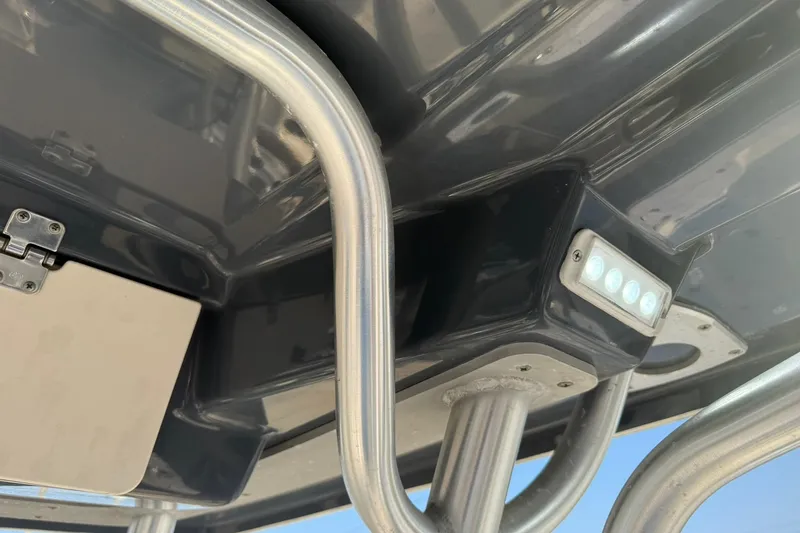 Slide: The Image of Close-up of 2017 Robalo R222ES boat's T-top structure and LED light. - 14