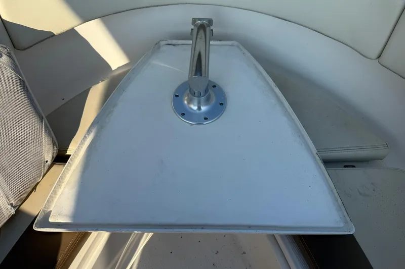 Slide: The Image of 2017 Robalo R222ES boat interior with a mounted table and seating area. - 16