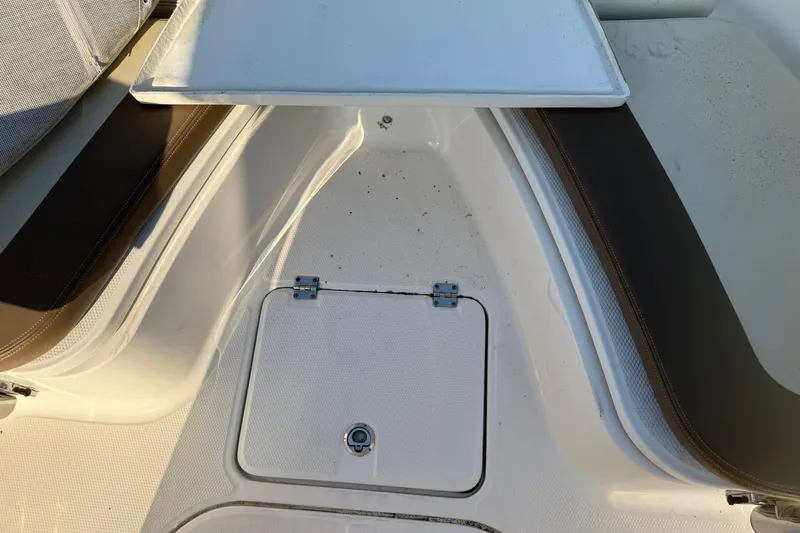 Slide: The Image of 2017 Robalo R222ES boat interior with storage compartment and seating. - 17