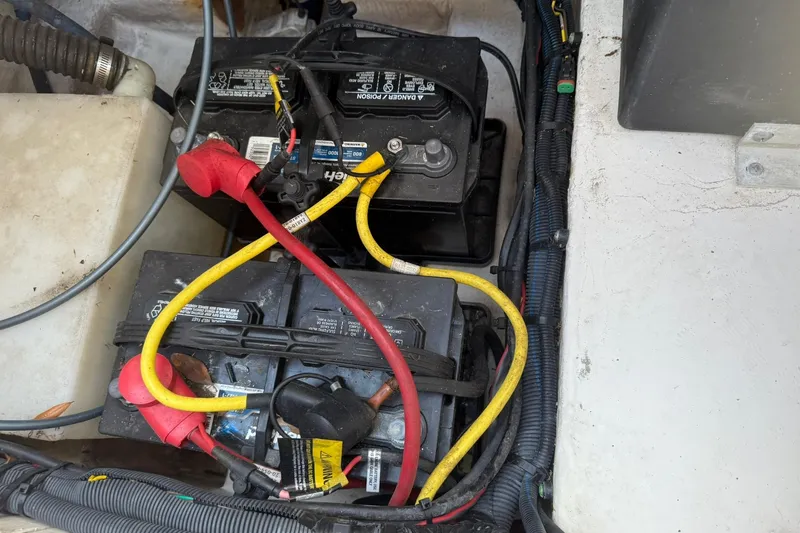 Slide: The Image of 2017 Robalo R222ES boat battery compartment with connected cables. - 21