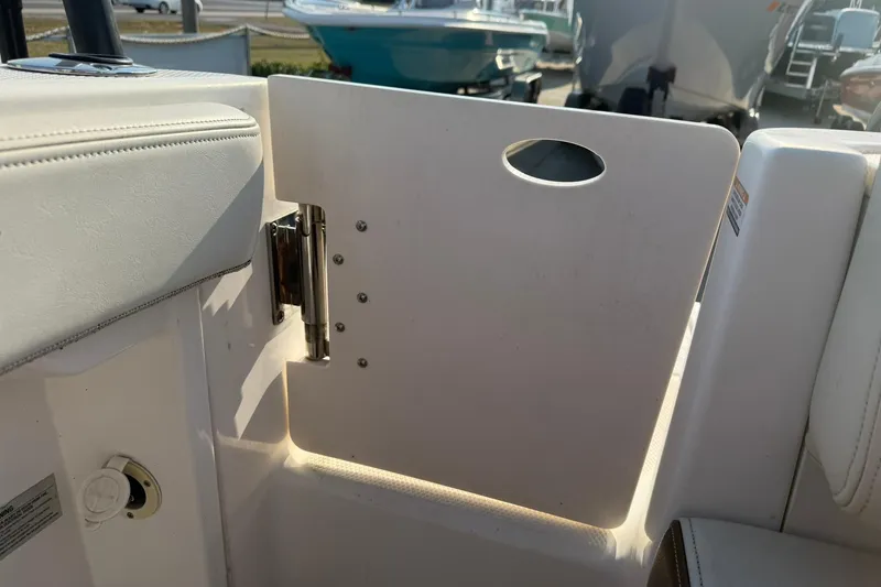 Slide: The Image of 2017 Robalo R222ES boat interior with white seating and hinged door. - 25