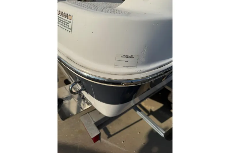 Slide: The Image of 2017 Robalo R222ES boat detail with visible branding and warning label. - 32