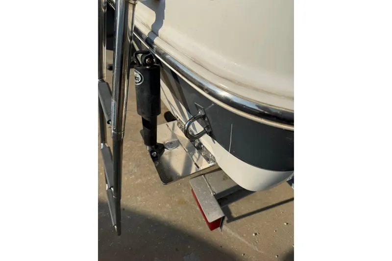 Slide: The Image of 2017 Robalo R222ES boat detail showing trim tab and ladder. - 33