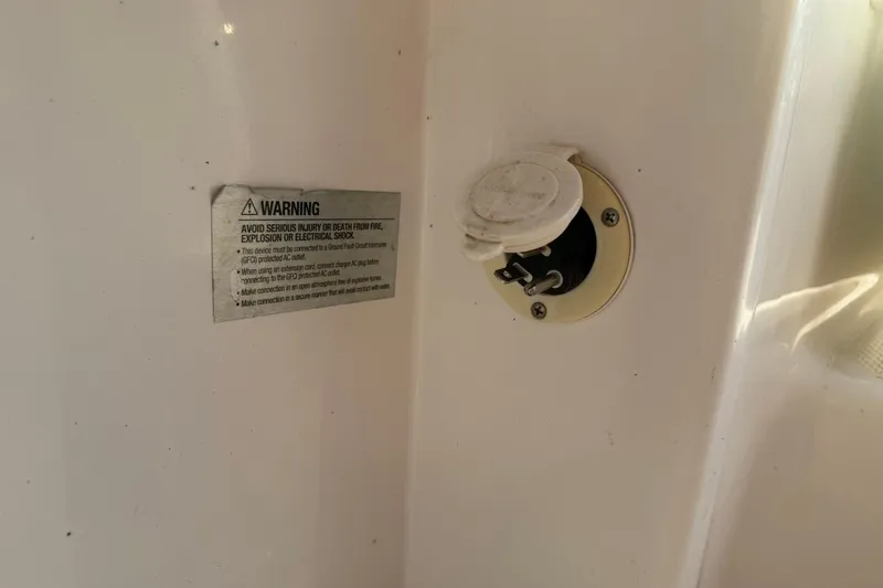 Slide: The Image of 2017 Robalo R222ES warning label and electrical outlet detail. - 34