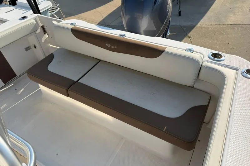 Slide: The Image of 2017 Robalo R222ES boat seating area with brown and white cushions. - 6
