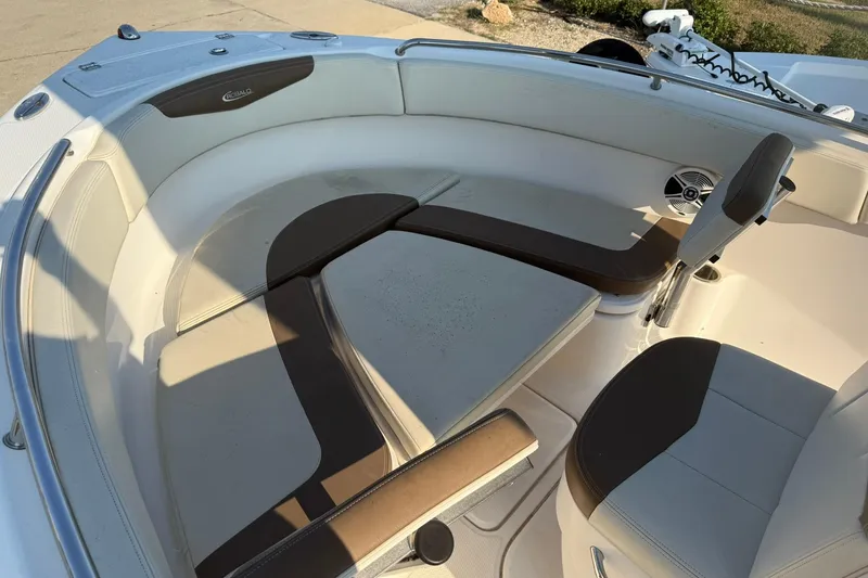 Slide: The Image of 2017 Robalo R222ES boat interior with cushioned seating and speaker. - 7