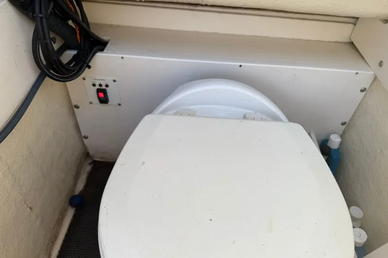 Slide: The Image of Boat toilet area in a 2017 Robalo R222ES, featuring a control panel and storage. - 9
