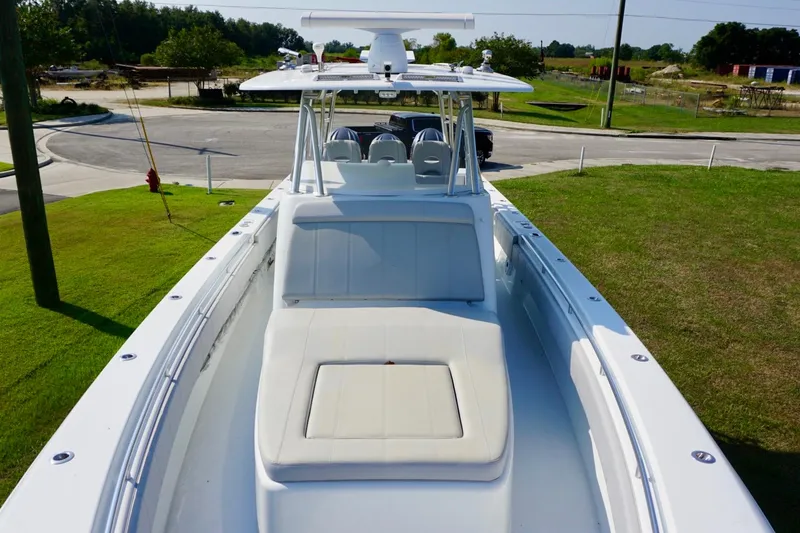 Slide: The Image of 2022 Contender 39 Fisharound boat cruising on open water with triple outboard engines. - 10