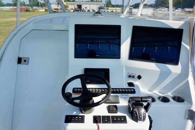 Slide: The Image of 2022 Contender 39 Fisharound boat cockpit with modern navigation displays. - 13