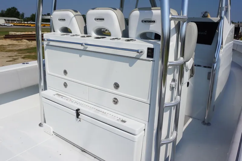 Slide: The Image of 2022 Contender 39 Fisharound boat deck with storage compartments and triple outboard engines. - 15