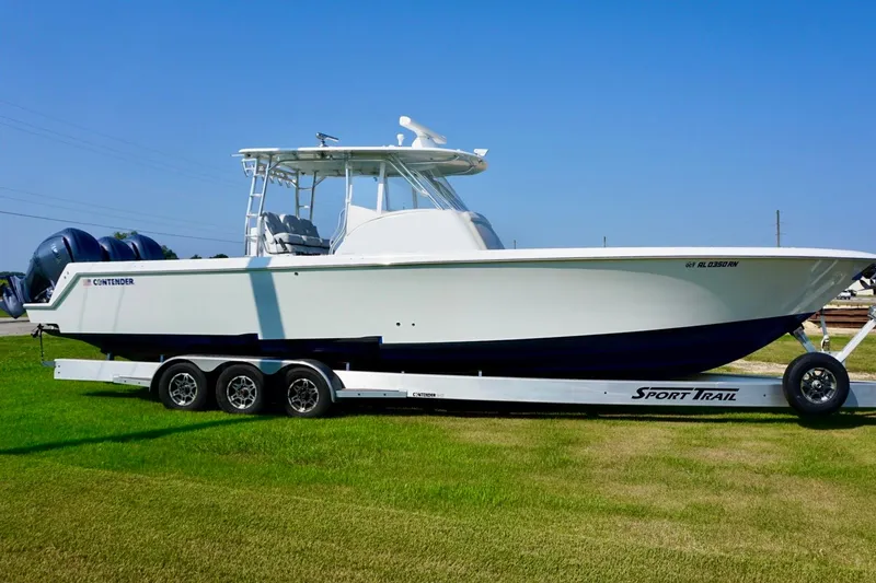 Slide: The Image of 2022 Contender 39 Fisharound boat cruising on open water, featuring dual outboard engines. - 4