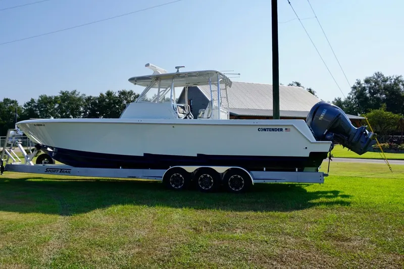Slide: The Image of 2022 Contender 39 Fisharound boat cruising on open water, featuring twin engines. - 6