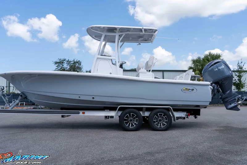 Slide: The Image of 2026 Sea Hunt BX 22 BR boat on trailer, featuring Yamaha outboard motor, under blue sky. - 10