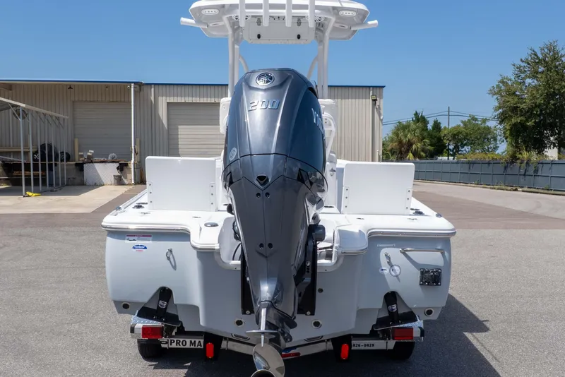Slide: The Image of 2026 Sea Hunt BX 22 BR boat with powerful outboard motor, parked outdoors. - 11