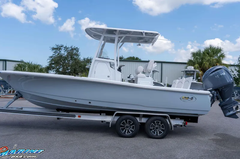 Slide: The Image of 2026 Sea Hunt BX 22 BR boat on trailer, parked outdoors under blue sky. - 12