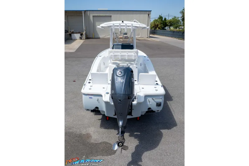 Slide: The Image of 2026 Sea Hunt BX 22 BR boat with powerful outboard motor, parked outdoors. - 13
