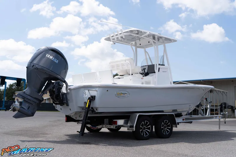 Slide: The Image of 2026 Sea Hunt BX 22 BR boat on trailer with Yamaha outboard motor, parked outdoors. - 24