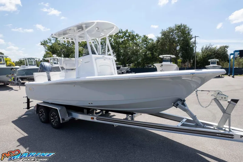 Slide: The Image of 2026 Sea Hunt BX 22 BR boat on trailer, parked outdoors under clear sky. - 27
