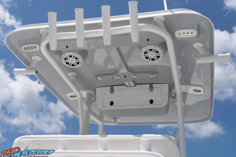 Slide: The Image of T-top of 2026 Sea Hunt BX 22 BR boat with rod holders and speakers against blue sky. - 38