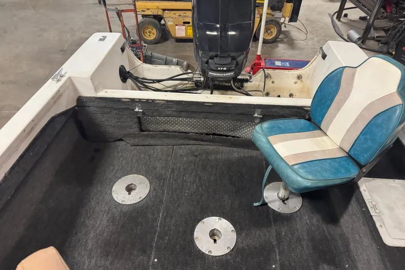 Slide: The Image of 1993 Yar-Craft 1890 CRS boat interior with blue and white seat, Mercury 175 engine. - 14
