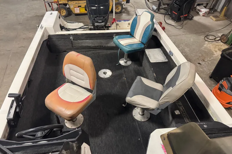 Slide: The Image of 1993 Yar-Craft 1890 CRS boat interior with three seats and Mercury engine. - 18