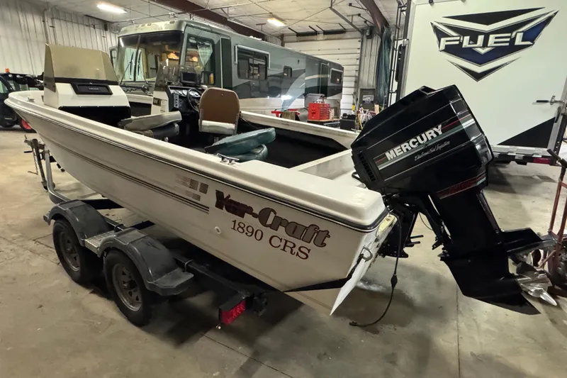Slide: The Image of 1993 Yar-Craft 1890 CRS boat with Mercury outboard motor in a garage setting. - 5