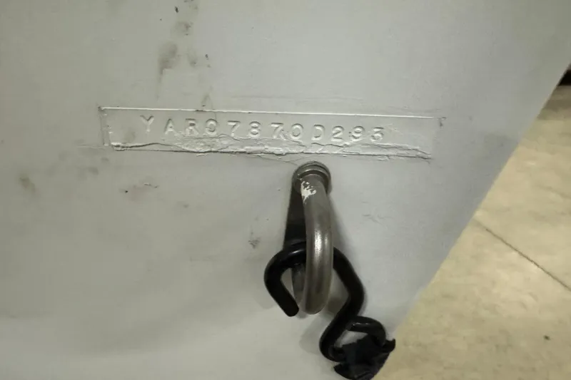 Slide: The Image of Serial number on 1993 Yar-Craft 1890 CRS boat hull with metal hook attached. - 6