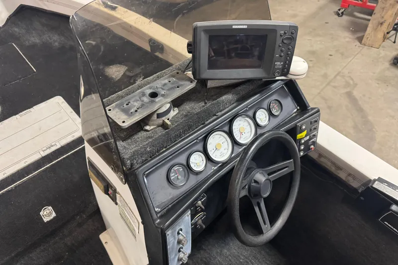 Slide: The Image of 1993 Yar-Craft 1890 CRS boat dashboard with steering wheel and gauges. - 9