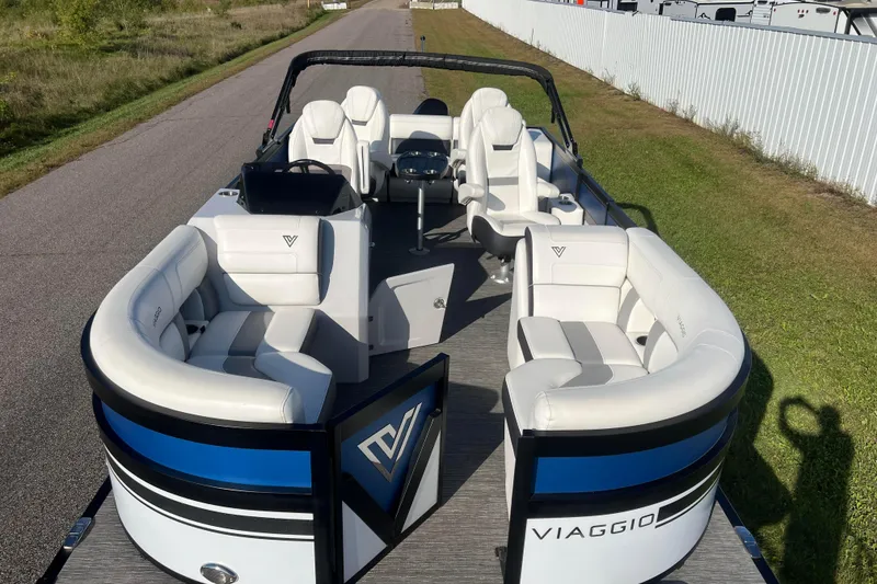 Slide: The Image of 2022 Viaggio Diamante Q pontoon boat with luxurious white seating on a sunny day. - 2