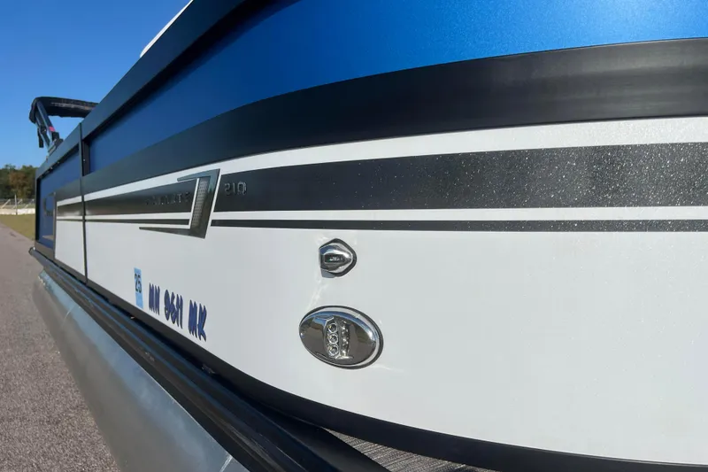 Slide: The Image of 2022 Viaggio Diamante Q boat with sleek blue and white design, side view. - 21
