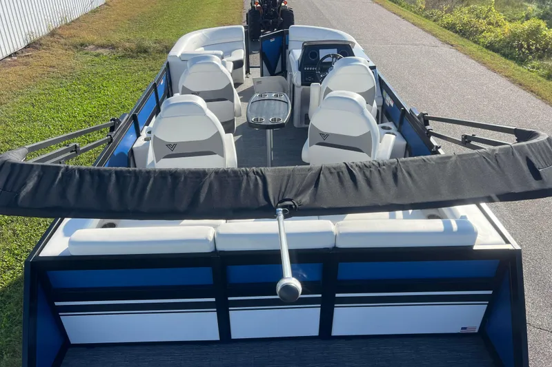 Slide: The Image of 2022 Viaggio Diamante Q pontoon boat with white seating and sleek design on a sunny day. - 3