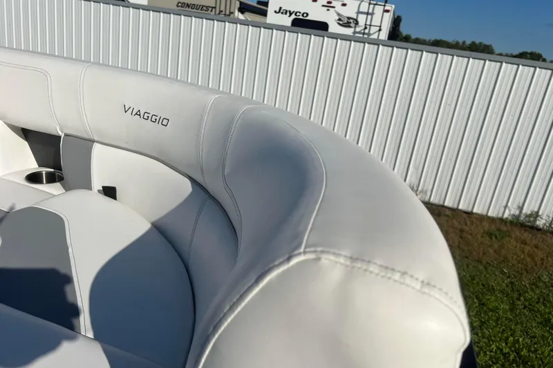 Slide: The Image of Luxurious white seating on 2022 Viaggio Diamante Q boat, featuring elegant stitching and cup holder. - 52
