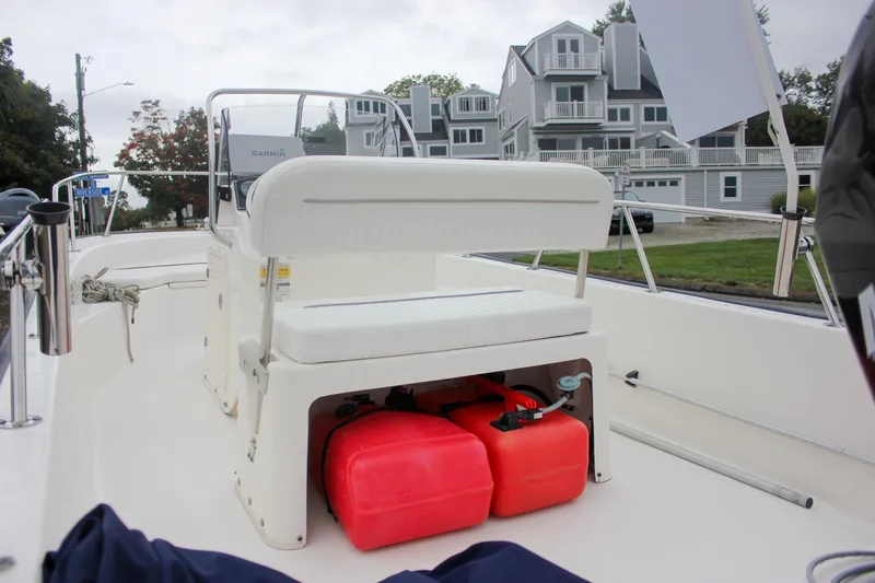 Slide: The Image of 2007 Boston Whaler 170 Montauk boat interior with seating and red fuel tanks. - 10