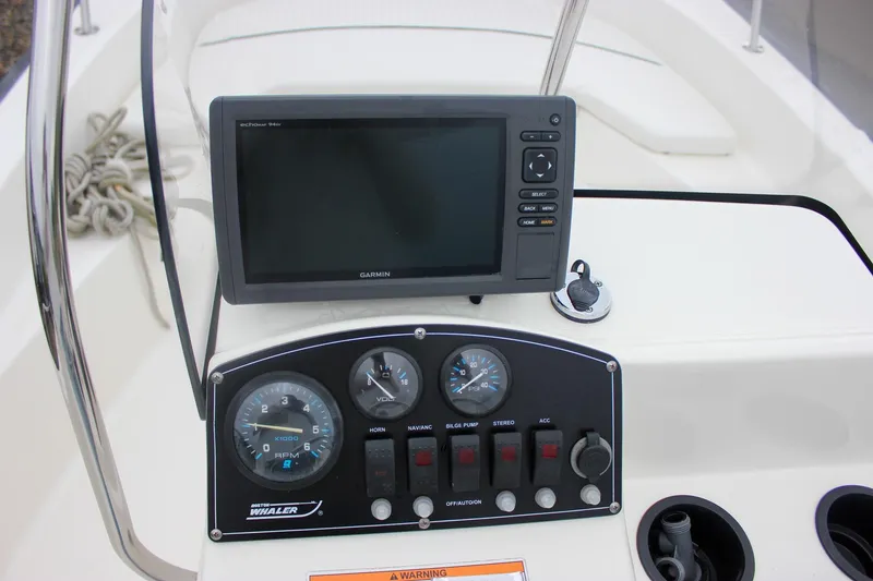 Slide: The Image of 2007 Boston Whaler 170 Montauk dashboard with Garmin GPS and control panel. - 15