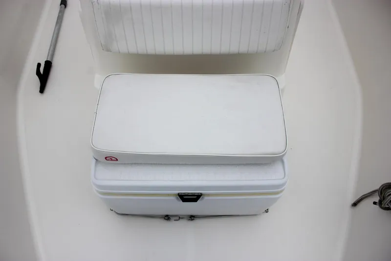 Slide: The Image of 2007 Boston Whaler 170 Montauk interior with white seating and storage. - 17