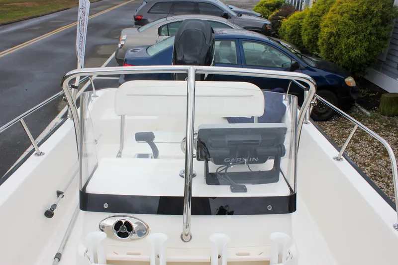 Slide: The Image of 2007 Boston Whaler 170 Montauk boat with Garmin navigation, parked near cars. - 19