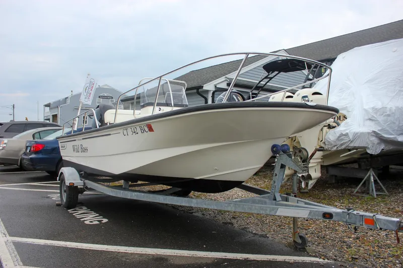 Slide: The Image of 2007 Boston Whaler 170 Montauk boat on trailer in parking lot. - 2