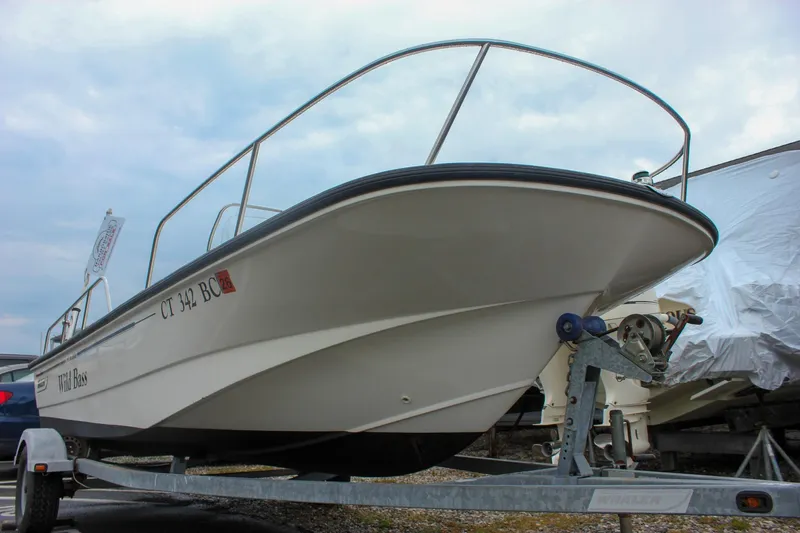 Slide: The Image of 2007 Boston Whaler 170 Montauk boat on trailer, side view, cloudy sky background. - 21