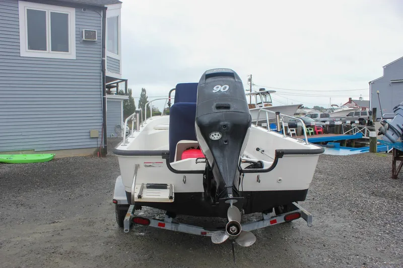 Slide: The Image of 2007 Boston Whaler 170 Montauk boat on trailer, rear view with outboard motor. - 3