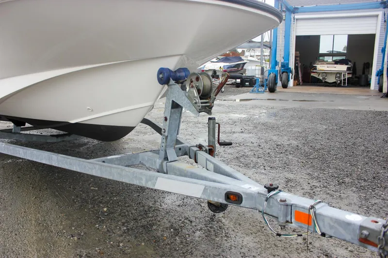 Slide: The Image of 2007 Boston Whaler 170 Montauk boat on trailer in a marina setting. - 4