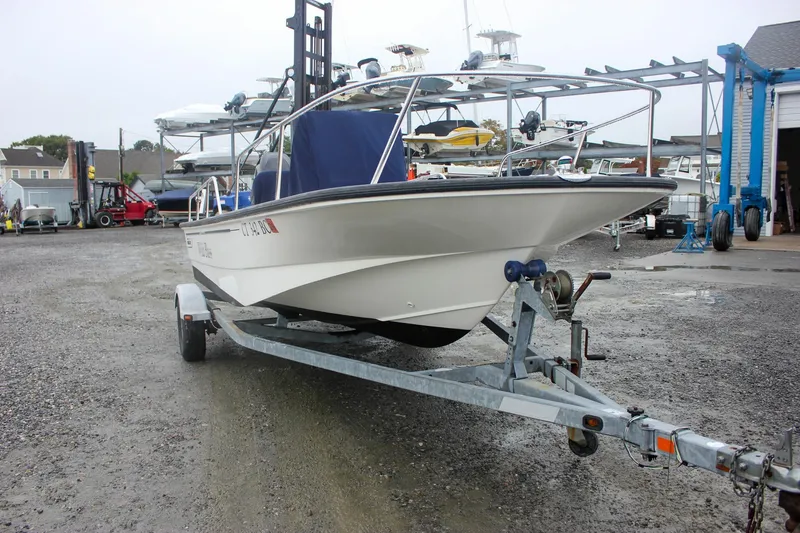 Slide: The Image of 2007 Boston Whaler 170 Montauk boat on trailer in a marina setting. - 5