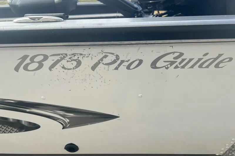 Slide: The Image of 2016 Lund 1875 Pro Guide boat with visible logo and design details. - 14