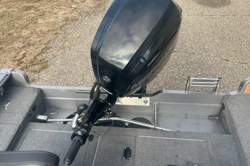 Slide: The Image of 2016 Lund 1875 Pro Guide boat with outboard motor on a textured surface. - 6