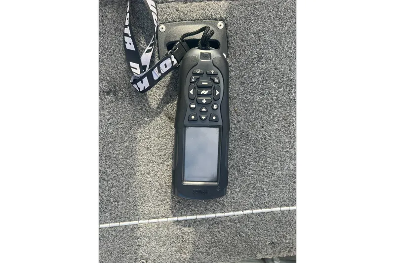 Slide: The Image of Remote control on Lund 1875 Pro Guide boat, 2016 model, resting on gray carpet. - 7