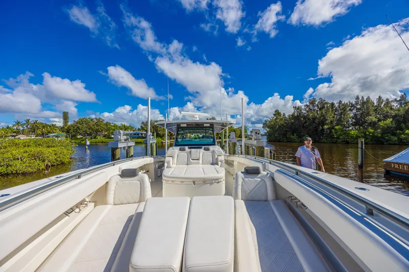 Slide: The Image of 2019 HCB 53 Sueños luxury boat docked under a vibrant blue sky. - 23