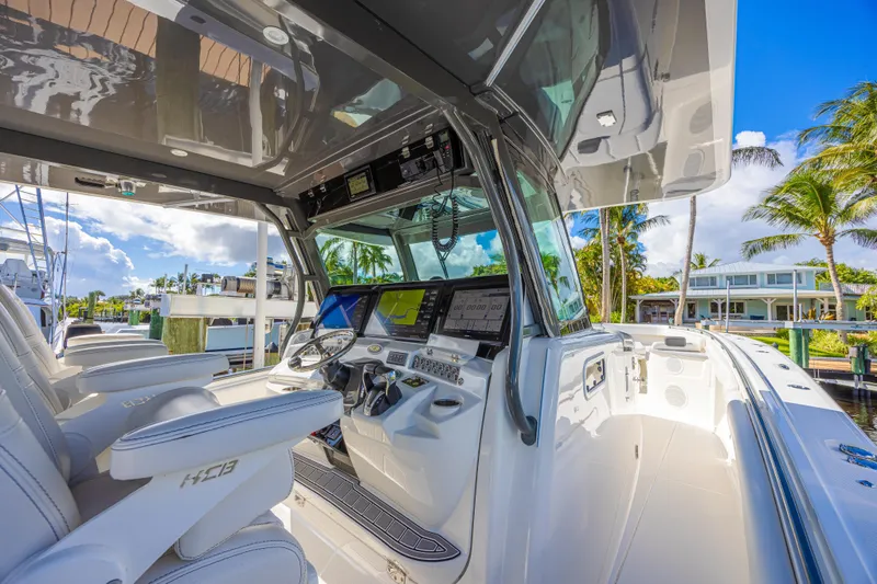 Slide: The Image of Interior view of 2019 HCB 53 Sueños boat with modern dashboard and seating. - 24