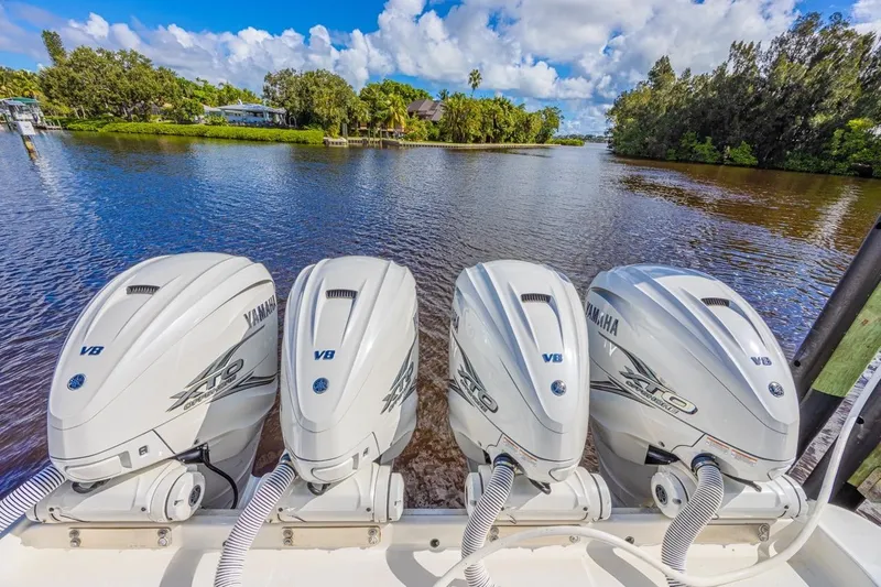 Slide: The Image of Four Yamaha outboard motors on a 2019 HCB 53 Sueños boat, with scenic river backdrop. - 8