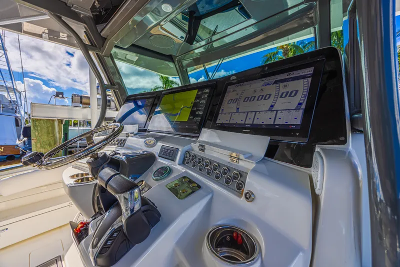 Slide: The Image of Helm of 2019 HCB 53 Sueños boat with advanced navigation displays and controls. - 18