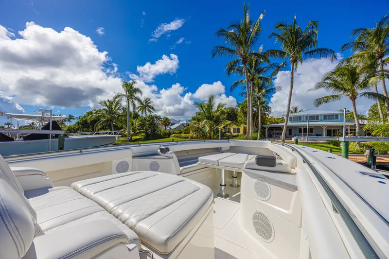 Slide: The Image of Luxurious 2019 HCB 53 Sueños boat interior with plush seating, palm trees, and blue sky backdrop. - 20
